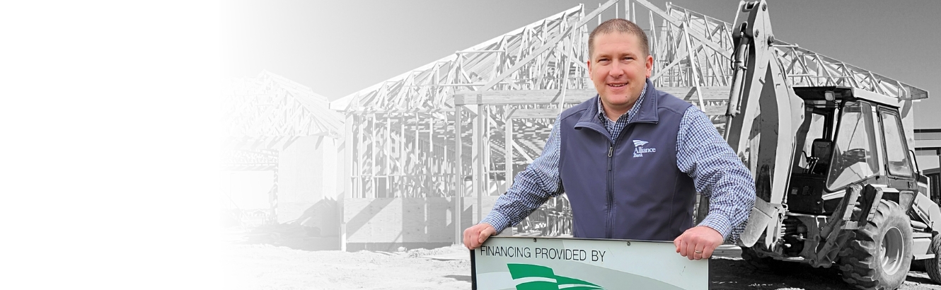 Image of Commercial Banker Andy Rummel with a construction site in the background.