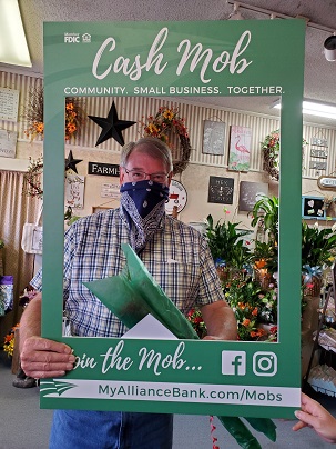 Man behind cash mob frame