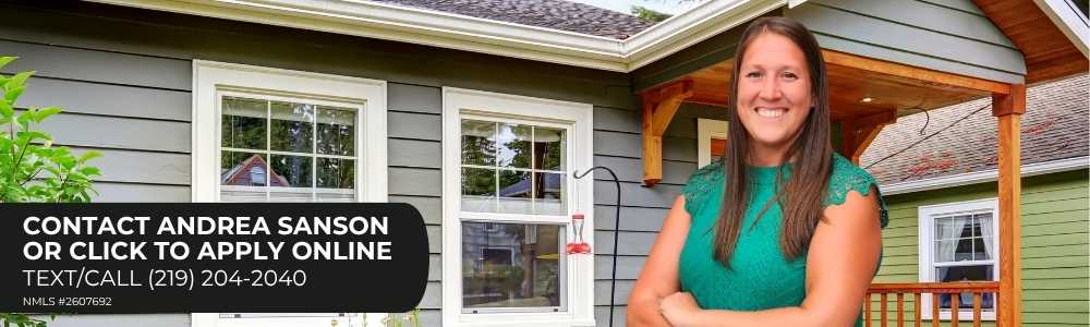 Photo of Mortgage Loan Originator Andrea Sanson standing in front of a house.