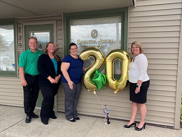 Alliance Bank Team surprising Client with Elevate Grant Award.