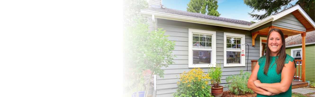 Photo of Mortgage Loan Originator standing in front of a house.